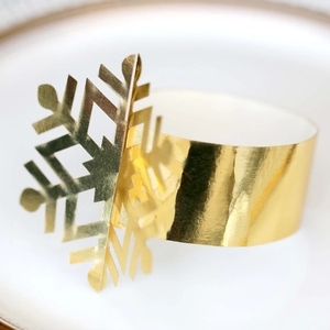 Golden snowflake napkin ring with reflective finish for Christmas table decor