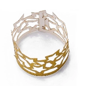 Close-up of a hollow crown-shaped napkin ring with sparkling golden glitter for parties