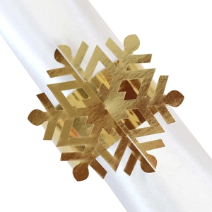 Detailed view of a golden snowflake napkin ring with a polished metallic mirror finish