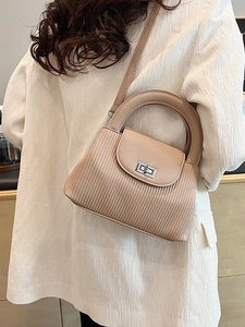 Beige retro bucket bag with pleated texture, top handle, and crossbody strap for women