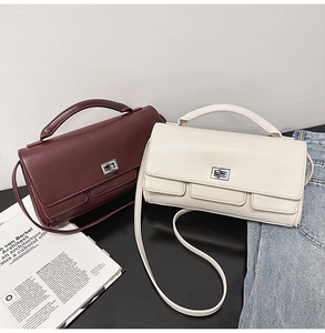 Detail view of burgundy and beige leather bags with silver clasps and pockets