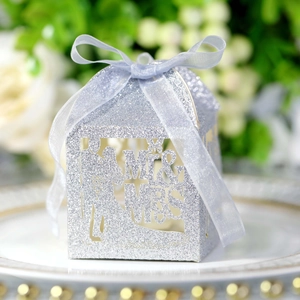 Macro detail of silver glitter wedding candy box with Mr & Mrs laser cut and ribbon