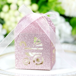 Detailed view of pink glitter gift box featuring a delicate stroller cutout and silk ribbon