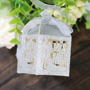 Close-up of silver glitter wedding candy box with laser-cut Mr & Mrs design and grey ribbon