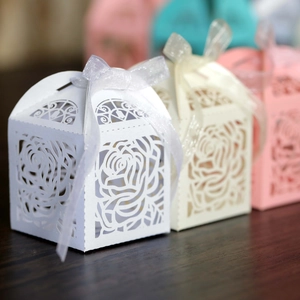 Close-up of laser-cut rose hollow candy box with organza ribbon for weddings