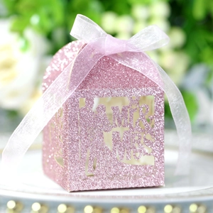 Detail of pink glitter gift box with Mr & Mrs laser-cut design and white ribbon