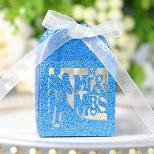 Detail of blue glitter Mr & Mrs candy box with laser-cut silhouette and organza ribbon