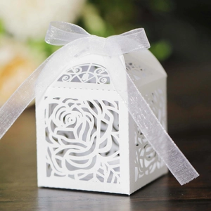 Elegant white laser-cut rose gift box with translucent ribbon bow on a wooden surface