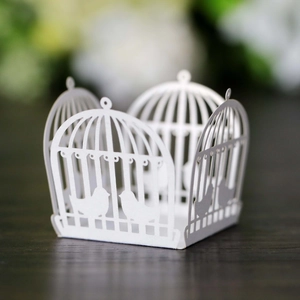 Macro detail of white laser-cut birdcage pattern wedding chocolate paper lace wrap