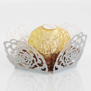 Detailed view of silver laser-cut floral candy wrapper with shimmering glitter finish