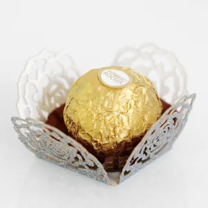 Silver laser-cut filigree chocolate wrapper with intricate rose patterns and glitter finish