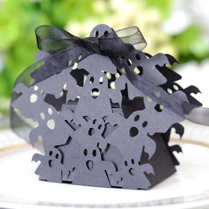 Close-up of black laser-cut Halloween ghost gift box with a delicate ribbon bow