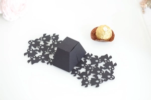 Detail of Halloween ghost hollow candy box with golden chocolate as size reference