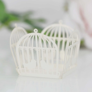 Macro detail of laser-cut white birdcage candy box with elegant floral hollow patterns