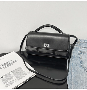 Classic black leather handbag with silver metallic twist lock and adjustable shoulder strap