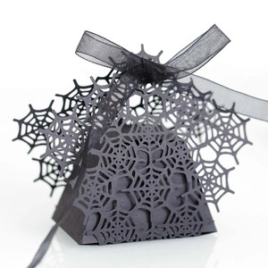 Detailed laser-cut spider web pattern on a matte black Halloween treat box with ribbon