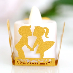 Golden laser-cut paper lantern with romantic couple silhouette and LED candle for wedding