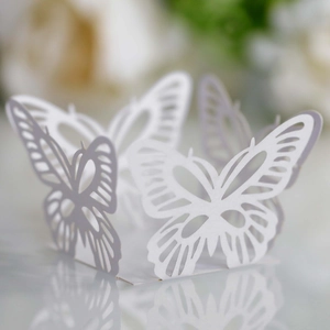 Macro shot of laser-cut white butterfly paper ring for weddings and party cake decorations