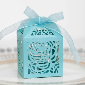 Detail of laser-cut rose hollow candy box in sky blue with matching ribbon bow