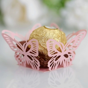 Close-up of pink laser-cut butterfly lace favor box for wedding candy and chocolate
