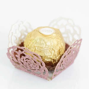 Close-up of pink glitter laser-cut rose chocolate wrapper for wedding party decor