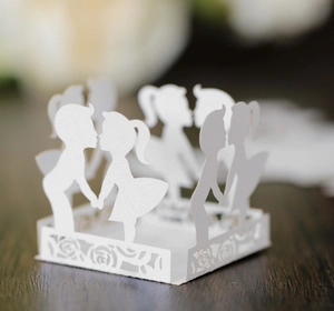 Detail of laser-cut white paper lantern with romantic boy and girl silhouette and roses