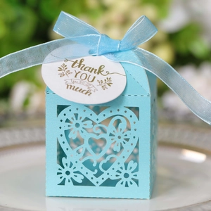 Sky blue laser-cut heart favor box with floral patterns and a ribbon bow tied on top