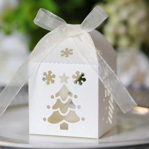 Laser-cut white Christmas gift box with snowflake patterns and silk ribbon bow detail