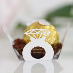 Detailed macro view of white laser-cut diamond ring chocolate holder with brown paper cup