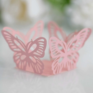 Macro detail of laser-cut pink butterfly paper ring for weddings and elegant parties