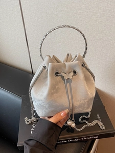 Silver velvet bucket bag with metal ring handle, butterfly accent and pearl drawstring