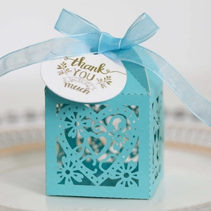 Close-up of tiffany blue laser-cut heart candy box with ribbon and thank you tag