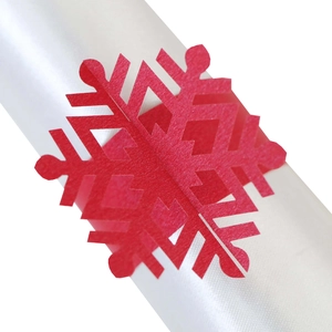 Detailed macro view of a laser-cut red snowflake paper napkin ring for Christmas decor