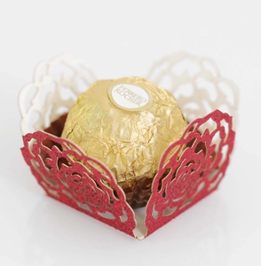 Macro shot of red glitter laser-cut rose hollow chocolate candy wrapper decoration