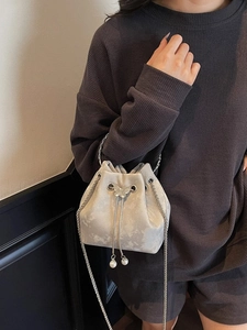 Silver-grey velvet bucket bag with butterfly metal piece and pearl drawstring detail