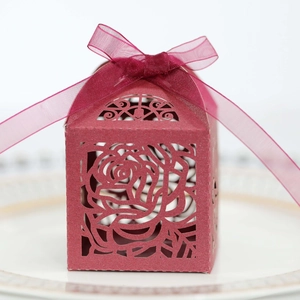 Detail of laser-cut burgundy rose wedding favor box with a matching chiffon ribbon bow