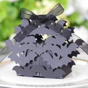 Detailed macro view of laser-cut black Halloween candy box featuring 3D bat hollow designs
