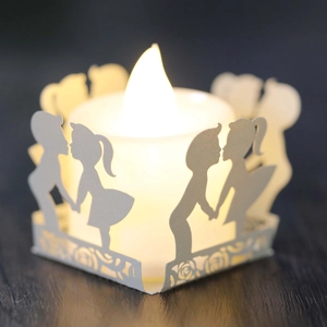 Detail of LED tea light with laser-cut paper shade featuring romantic silhouette and roses