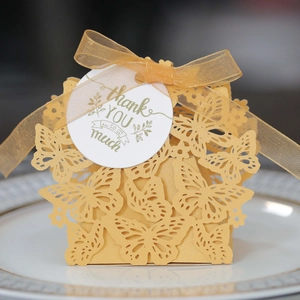 Detail of laser-cut butterfly candy box with Thank You tag and gold organza ribbon