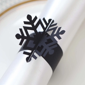 Detail shot of black snowflake napkin ring with intricate laser-cut hollow design