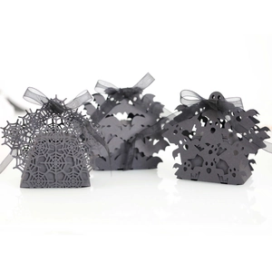 Laser-cut Halloween gift boxes featuring spider web, bat, and ghost designs with ribbons