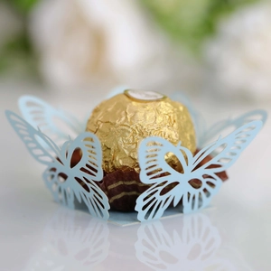 Detailed laser-cut light blue butterfly paper lace wrapper for luxury chocolate decoration