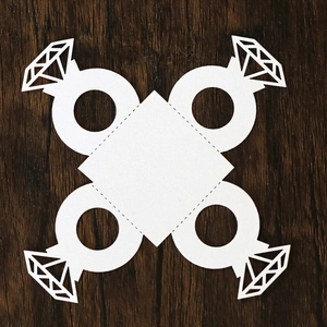 Detailed laser-cut white cardstock diamond ring shape for wedding candy box decoration