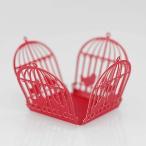 Detailed laser-cut red birdcage candy box with intricate floral lace for wedding party