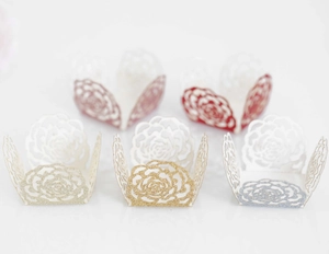 Laser-cut glitter paper chocolate cups in gold and silver with elegant rose flower patterns