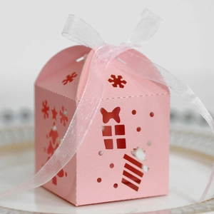Detailed macro view of laser-cut pink Christmas candy box with tree and snowflake patterns
