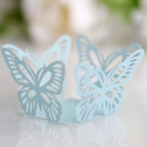 Macro detail of laser-cut light blue butterfly paper decoration for wedding party decor