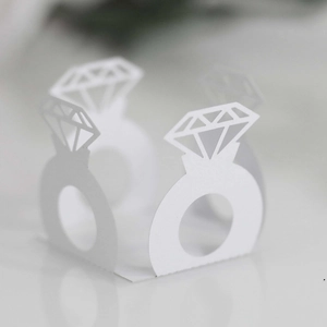 Detailed laser-cut white paper ring holder for wedding candy and party decorations
