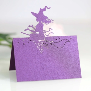Macro detail of purple glitter laser-cut witch silhouette Halloween place card