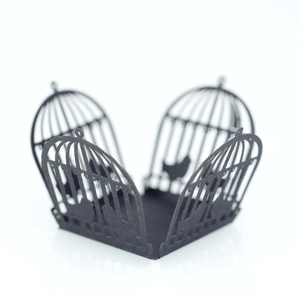 Macro view of black laser-cut birdcage candy box with intricate lace patterns